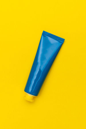 Bright Blue Tube on Vibrant Yellow Background: Minimalist Skincare Packaging