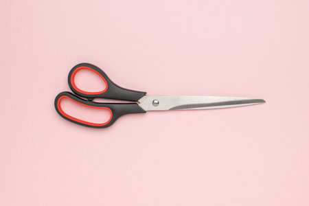 Black and Red Scissors on Pink Background: Essential Office and Craft Tool