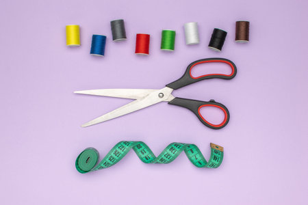 Vibrant Sewing Essentials: Colorful Threads, Scissors, and Measuring Tape on Pastel Background