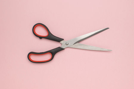 Scissors on Pink Background: Creative Design and Crafting Tool for Artistic Projects