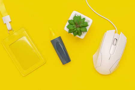 Yellow Desk Essentials with Mouse, Badge, Highlighter, and Succulent on Vibrant Background