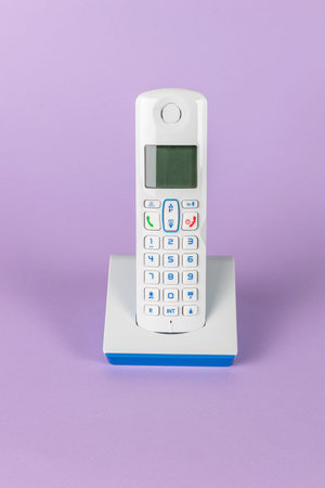 Modern Wireless Landline Phone on Purple Background for Contemporary Home Office Setup