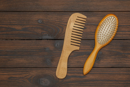 Wooden Comb and Brush Set on Rustic Wooden Background