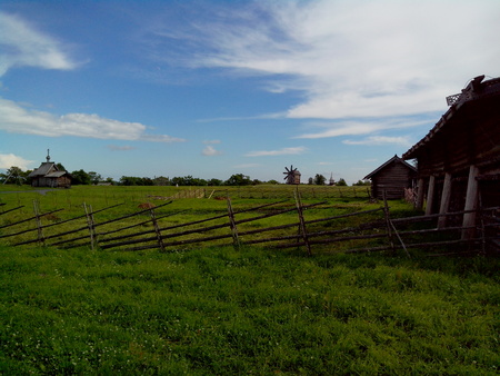 view of Kizhi Island, the historic site of churches and bell tower, a large historic log wood house on the marshy banks of islandの写真素材