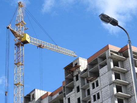 Construction site cranes, work on the construction of the house