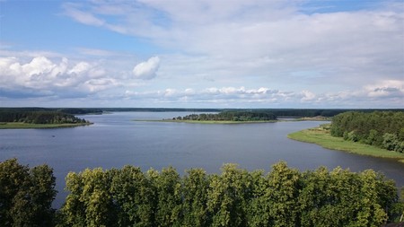 Blue sky and blue lake in summer. White clouds are reflected in the water. The famous lake Seliger....