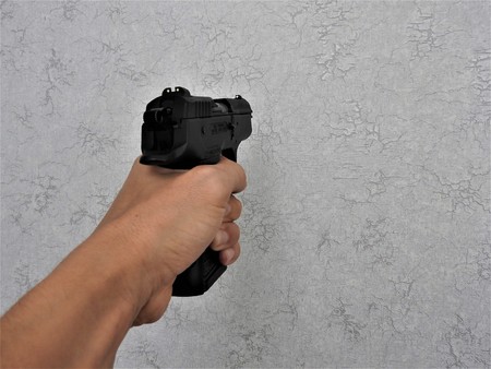 Black gun 9mm in the hand of a man.