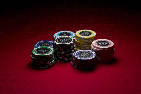 Poker chips on red surface