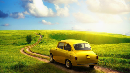 little retro car goes by wonderful countryside road at sunset 3dの写真素材