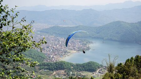 Paragliders flying against the Himalayas , Pokhara , Nepal.の写真素材