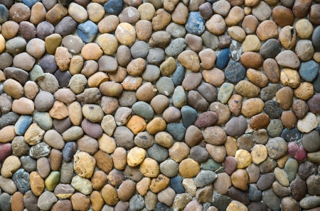 Pebbles stone wall background の写真素材
