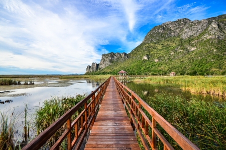 red wooden bridge on water under cloudy sky , khao samroiyod national park, thailand の写真素材