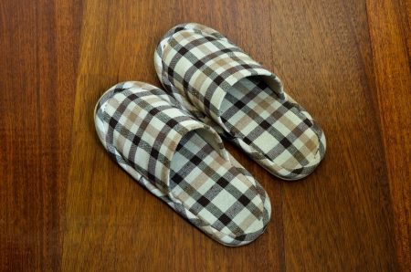 house slippers on the brown wood floorの写真素材