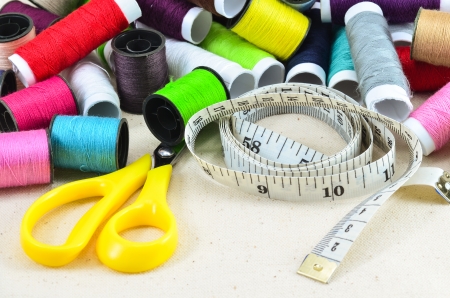 colored spools of threads and sewing kit