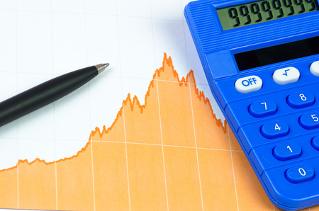 calculator, pen and graph of business analysisの写真素材