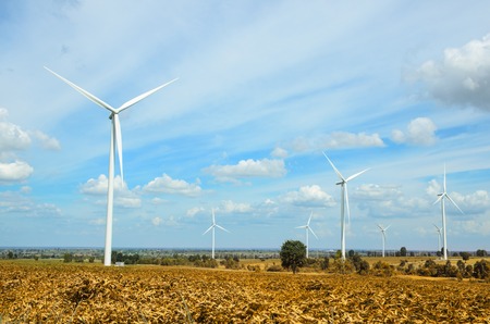 wind turbine against cloudy blue sky background