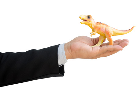 business man with dinosaurs in hand isolated on white backgroundの写真素材