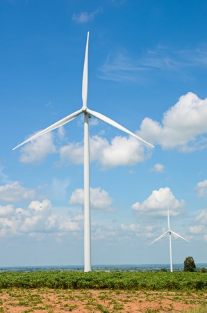 wind turbine against cloudy blue sky backgroundの写真素材
