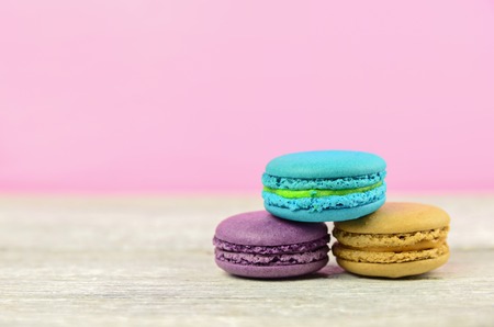 colourful stack flavoured macaron on white wood backgroundの写真素材
