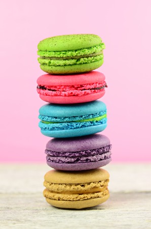 colourful stack flavoured macaron on white wood backgroundの写真素材