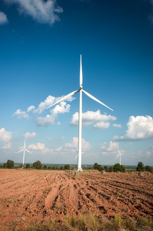 wind turbine against cloudy blue sky background