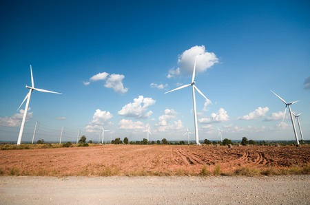 wind turbine against cloudy blue sky backgroundの写真素材