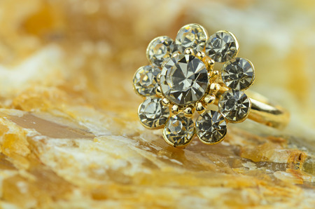 gold heart shape ring on marble stone backgroundの写真素材