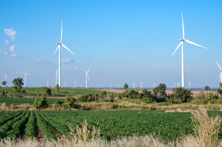 wind turbine against cloudy blue sky background