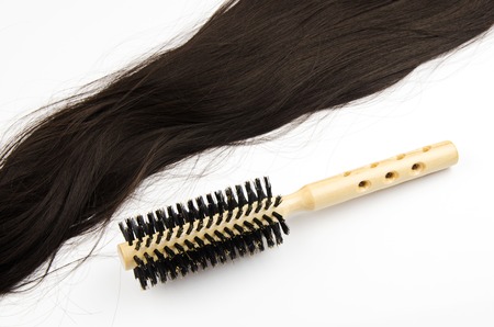 hair brush with long hair on white backgroundの写真素材