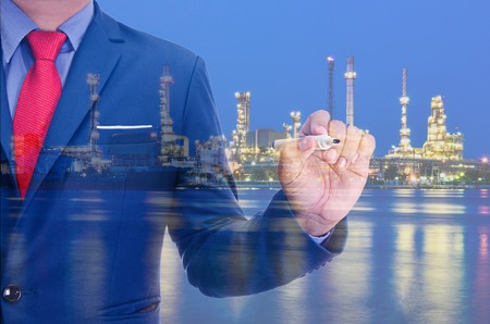 Business man and Oil refinery at twilight backgroundの写真素材