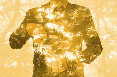 Double exposure of business man hand holding knifeの写真素材