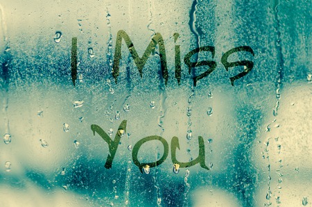 natural water drops on glass window with the text "I miss you"の写真素材