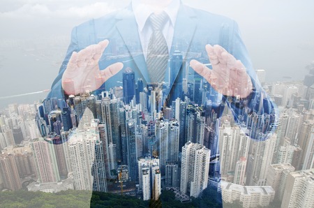 Double exposure of business man with modern building backgroundの写真素材