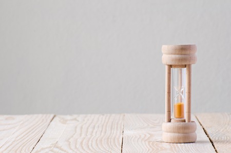 Sandglass on the wooden tableの写真素材