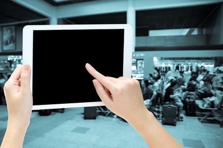 woman hand holding the phone tablet on blur backgroundの写真素材