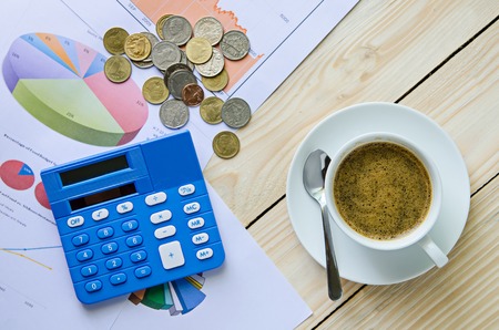 coffee cup and business graph on wooden tableの写真素材