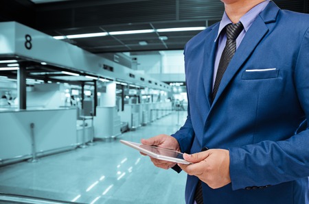 business man holding tablet in hand in blur backgroundの写真素材