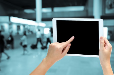 woman hand holding the phone tablet on blur backgroundの写真素材