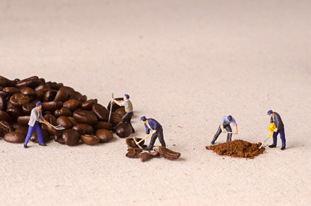 Miniature people working on coffee blend processの写真素材