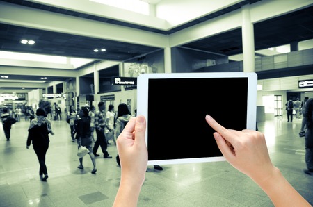 woman hand holding the phone tablet on blur backgroundの写真素材