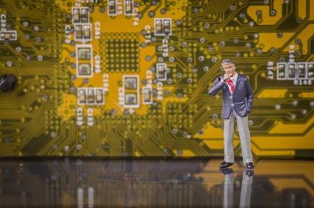 miniature business man on modern circuit board backgroundの写真素材