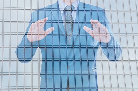 business man with modern building backgroundの写真素材