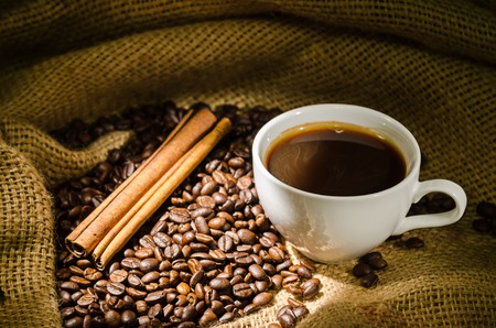 White coffee cup and coffee beans aroundの写真素材