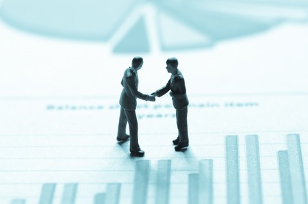 miniature business man on the graphの写真素材