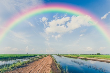 Rainbow and White clouds in blue sky backgroundの写真素材