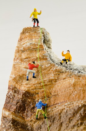 Miniature climbers climbing rocksの写真素材