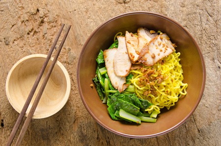 Yellow noodles served with sliced porkの写真素材