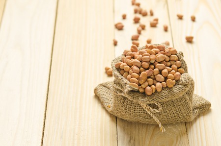 beans in sack on wood tableの写真素材