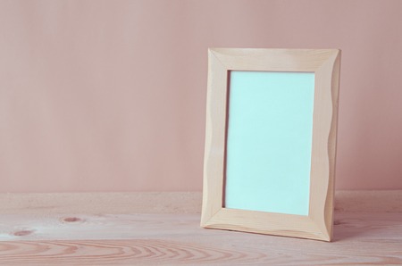 blank photo frame on wooden tableの写真素材