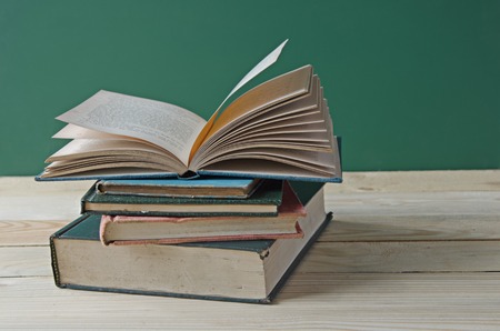 A pile of books on wooden table